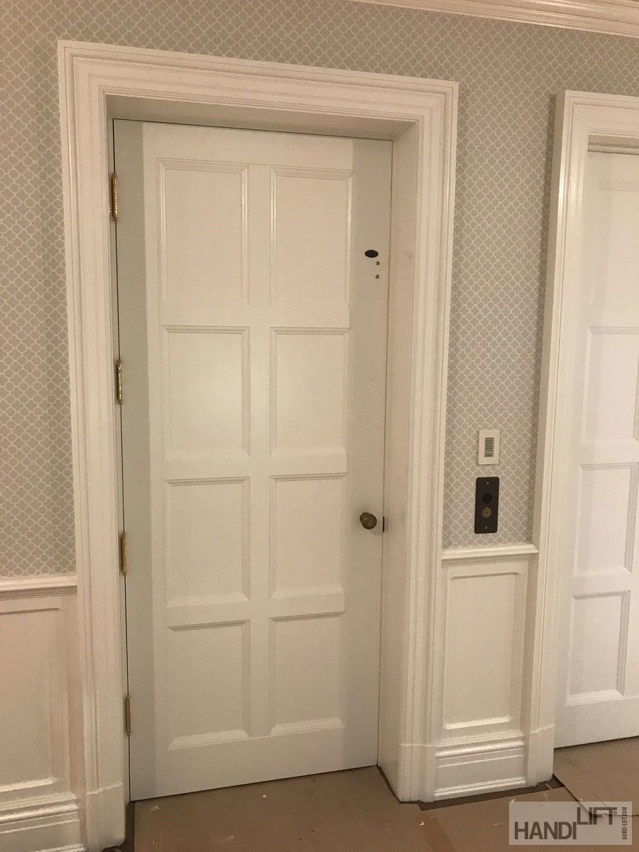 Photo of the elevator with the door closed, from the outside, highlighting how it blends into the decor of the home.